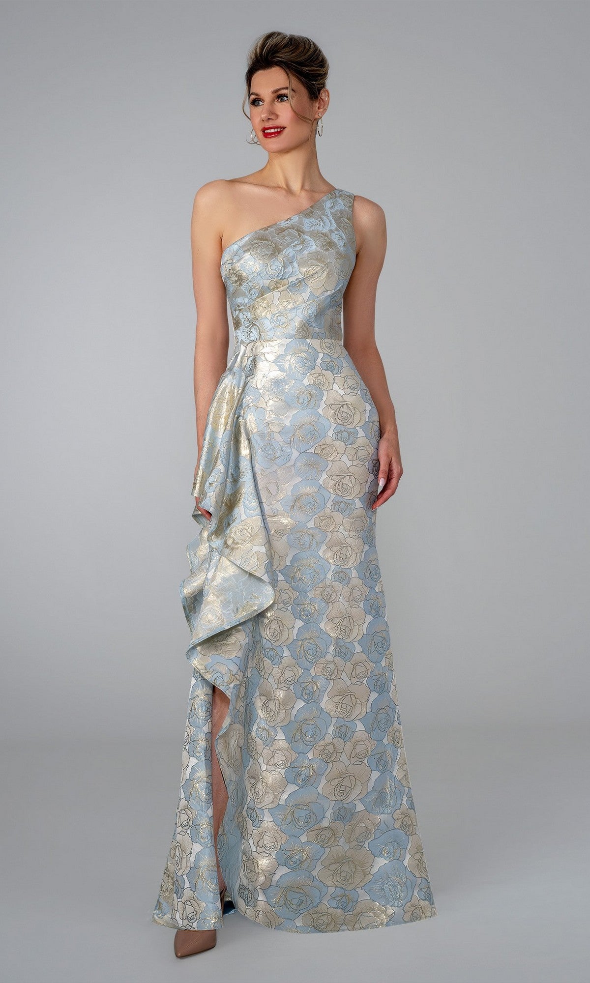A woman wearing the Long Formal Dress: Stella Couture 26315 in blue stands against a plain gray background.